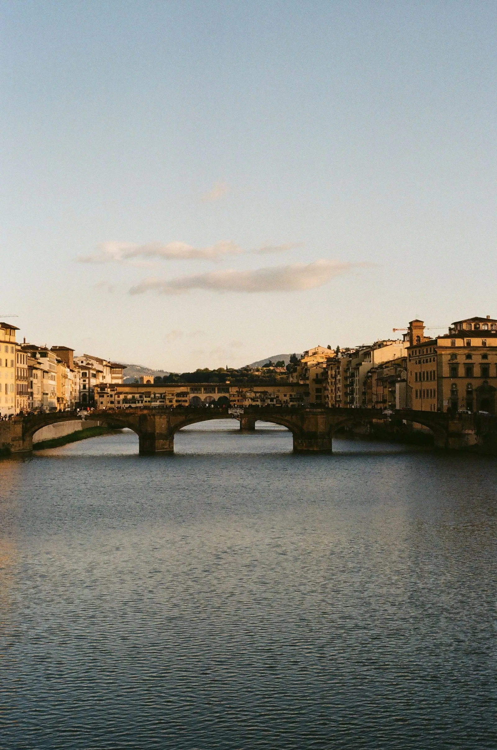 De Arno en de bruggen van Florence in warm avondlicht